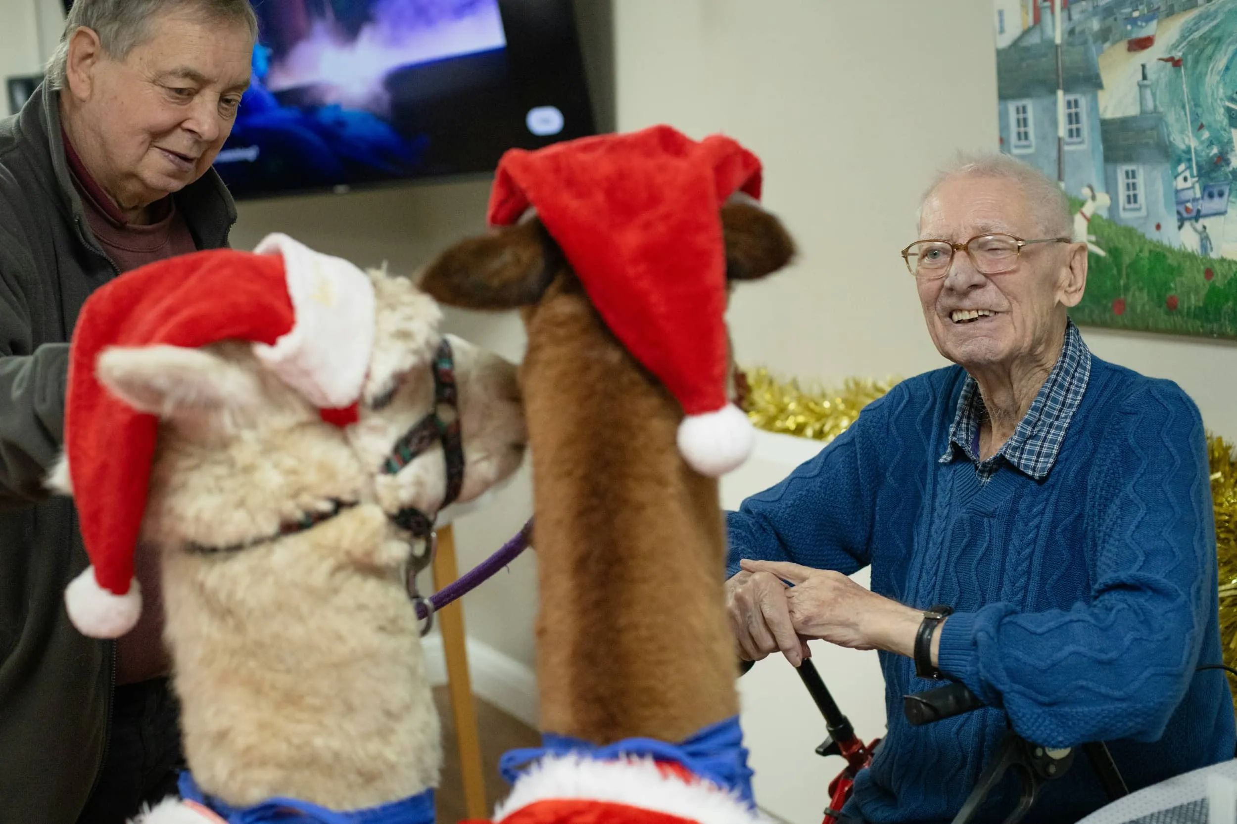 A resident smiling during an alpaca visit